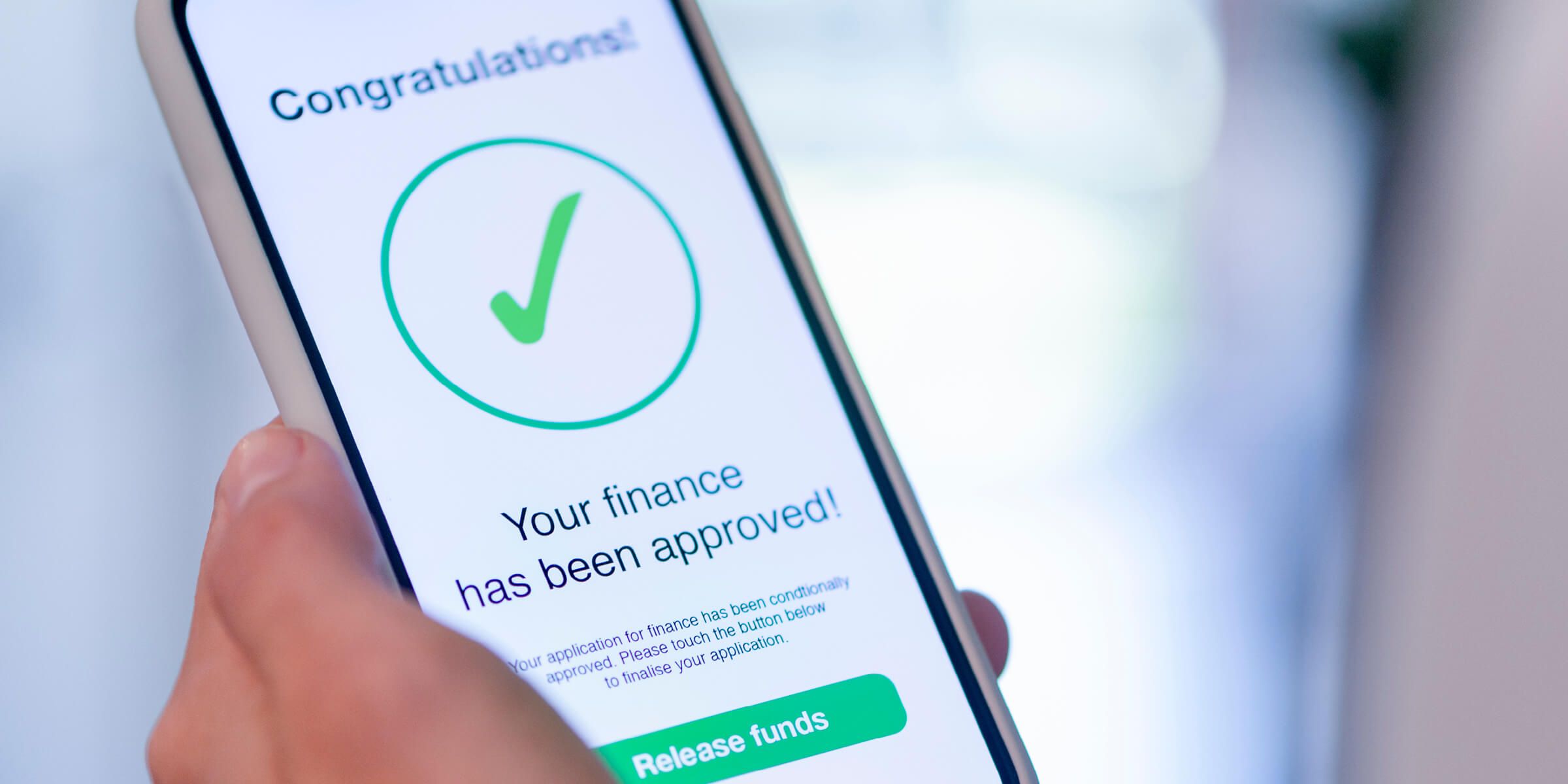 Notice of approval for financing shown on a phone.